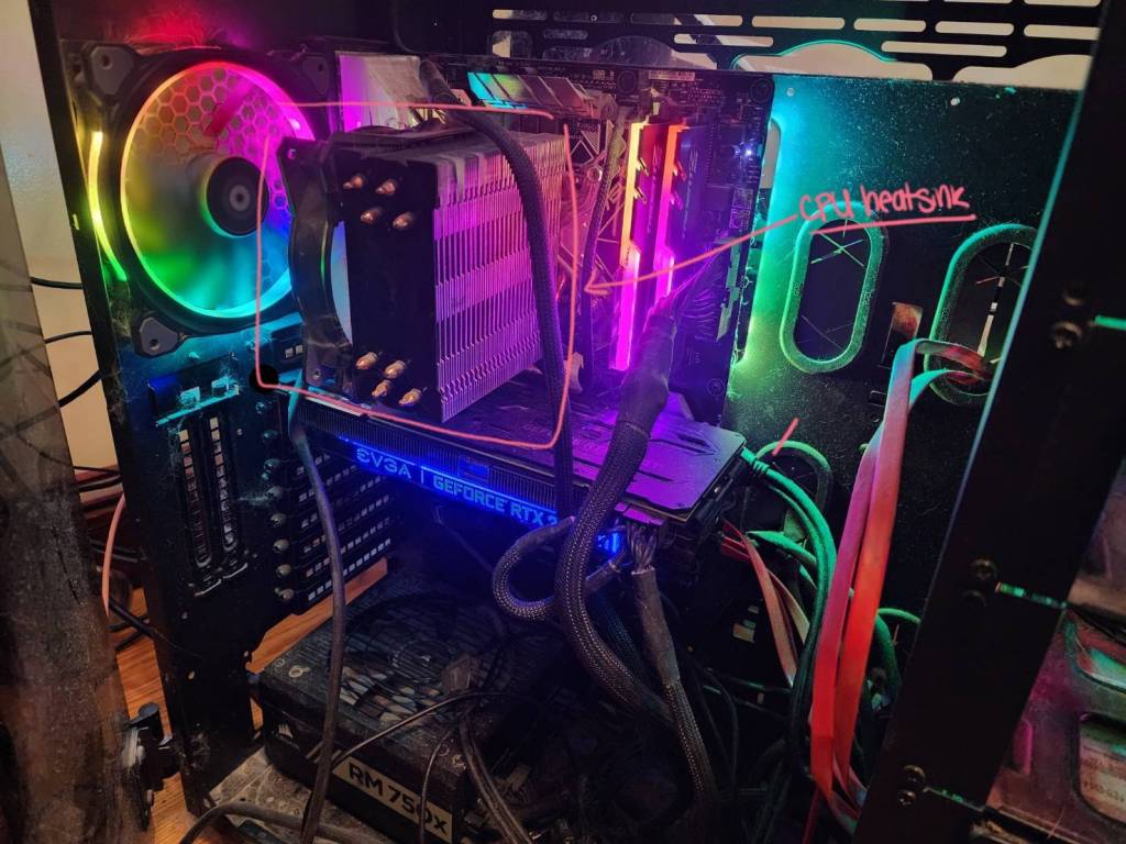 An image of the inside of a custom built PC with rainbow LEDs with the CPU heatsink visually highlighted.