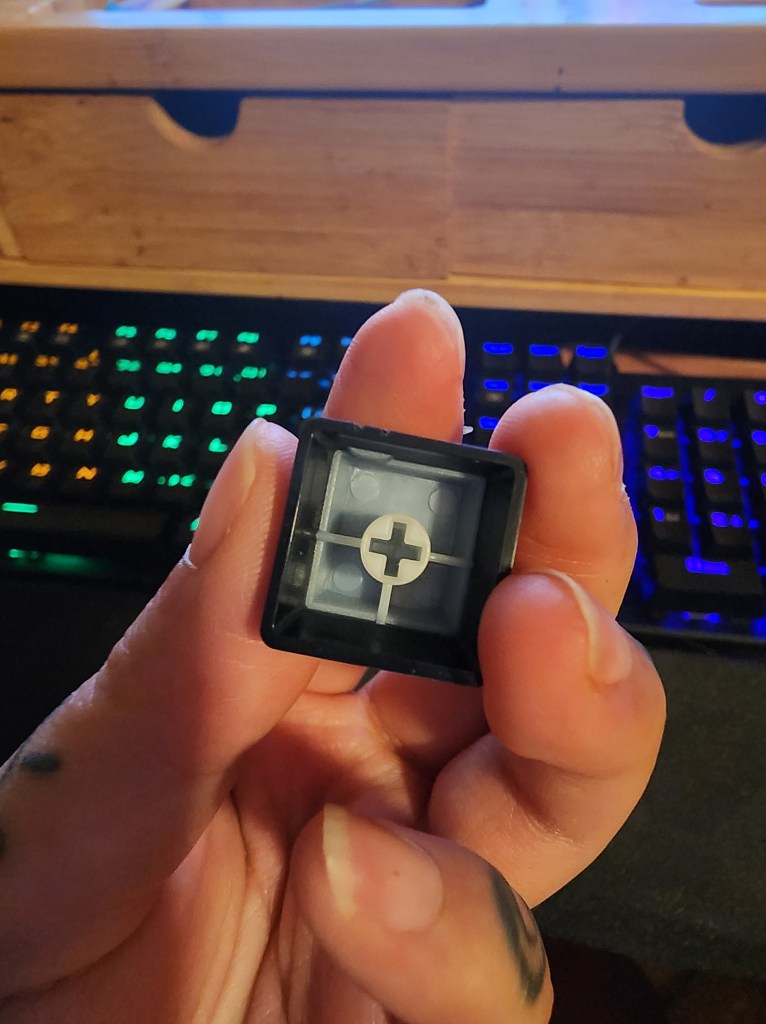 A close up of the underside of the escape keycap from a RisoPhy Mechanical Gaming Keyboard RGB.